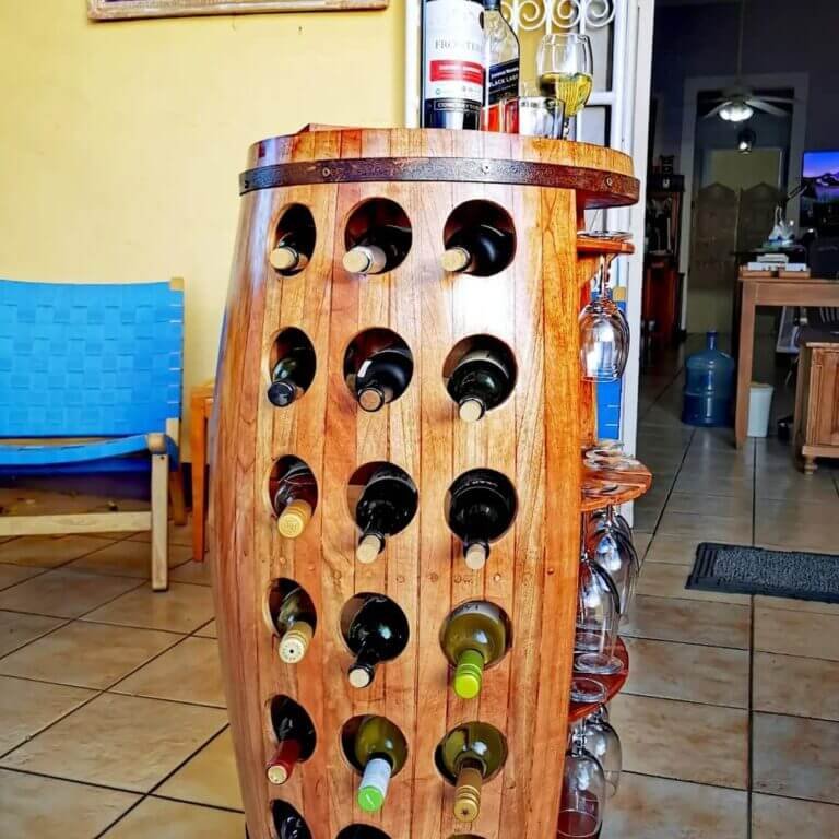 Wine rack with high quality design made of wood in the shape of a wine barrel. The side of the bottle holder offers the possibility of storing glasses. The rack offers space for up to 10 standard wine bottles,